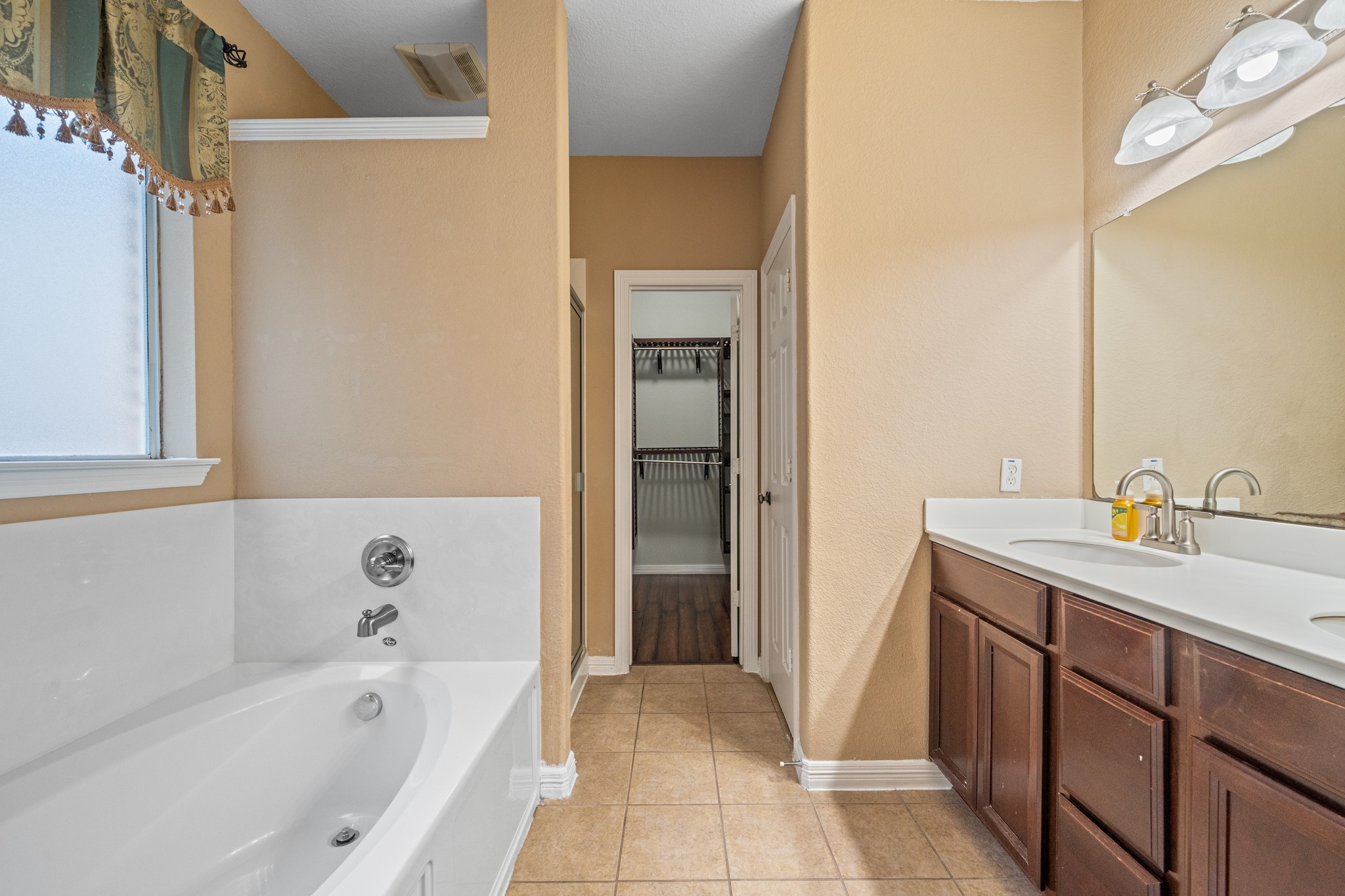 8711 Preston Field Lane Houston, TX 77095 - Photo 24 of 41 a bathroom with a bathtub sink and mirror