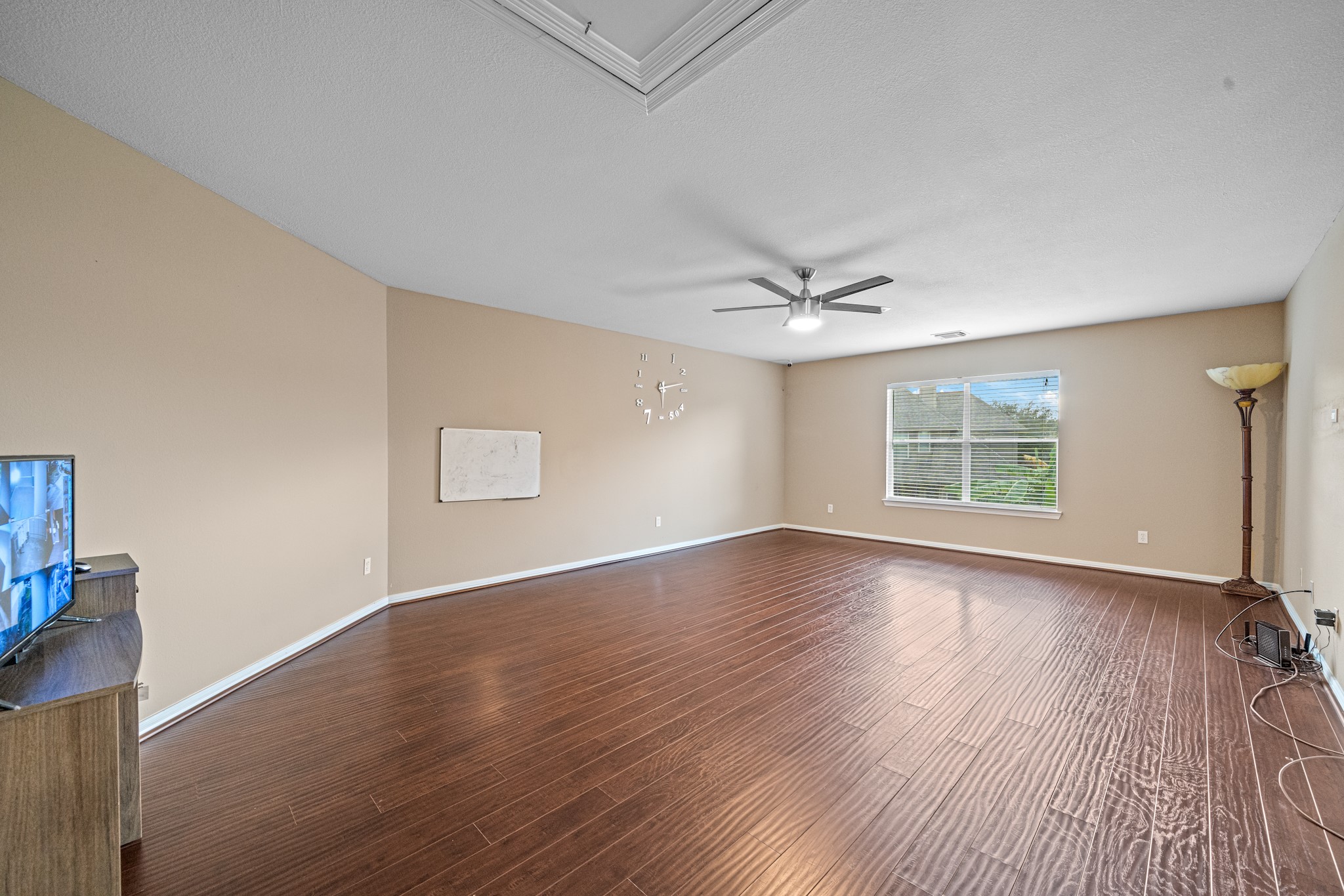 8711 Preston Field Lane Houston, TX 77095 - Photo 26 of 41 a view of an empty room with wooden floor and a window