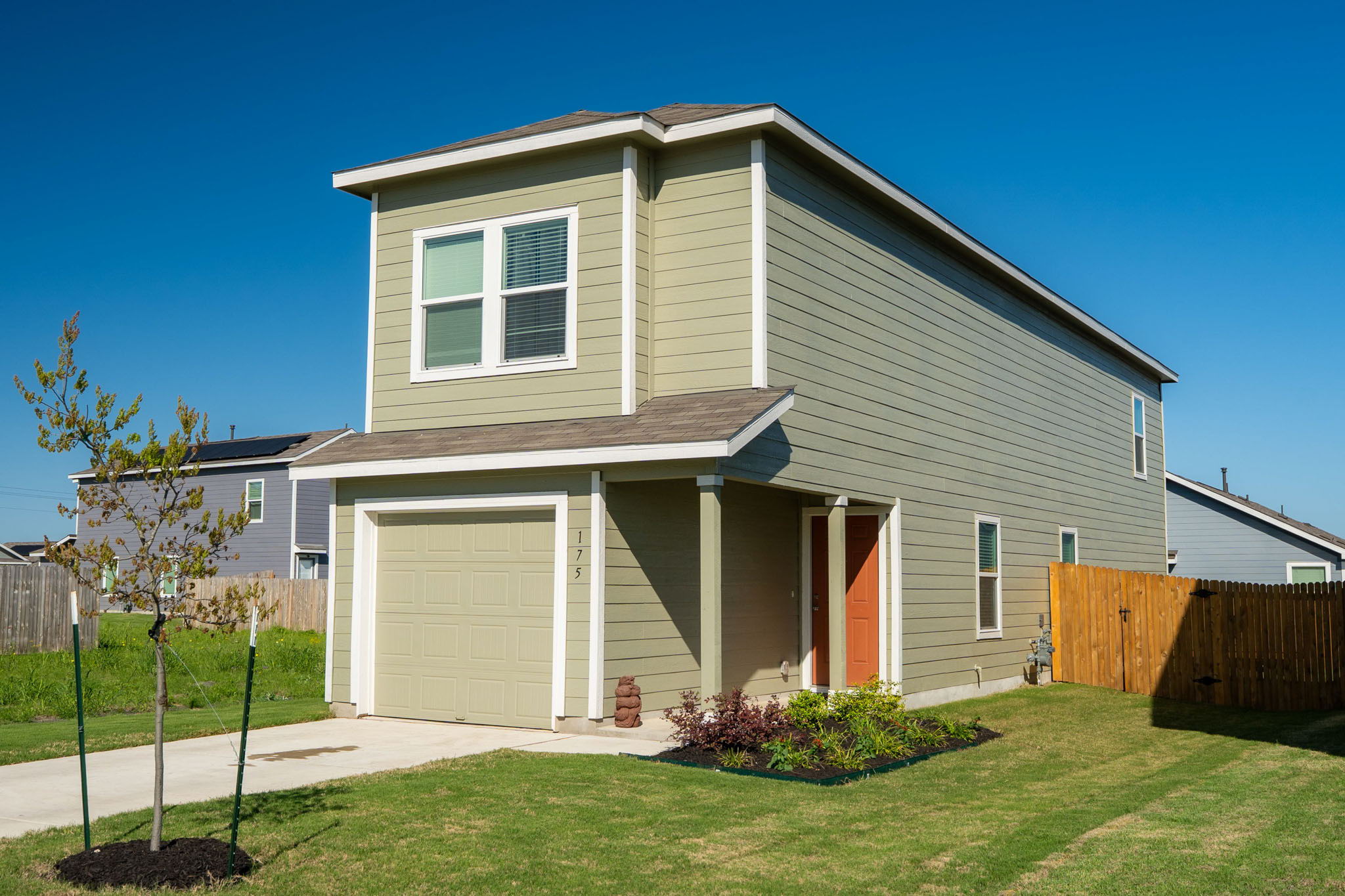 175 Amber Glen Maxwell, TX 78656 - Photo 2 of 27 a front view of a house with a yard