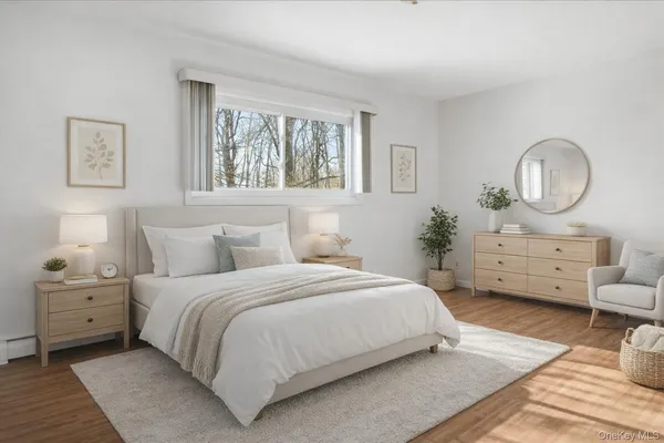 a bedroom with a bed a mirror and a window