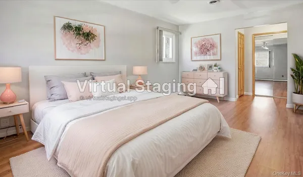 a bedroom with bed and painting on the wall