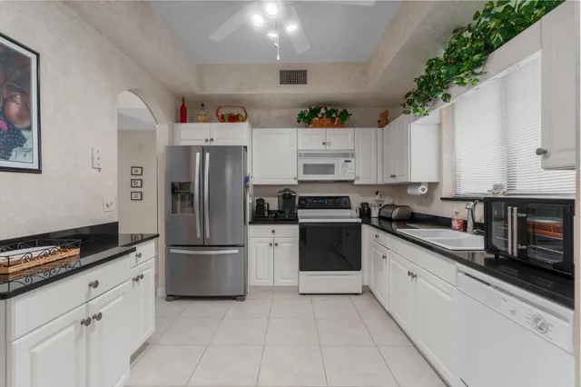 a kitchen with stainless steel appliances and white cabinets