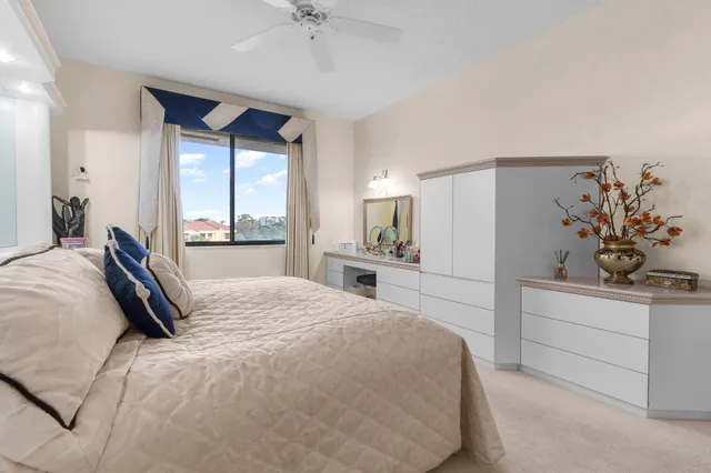 a bedroom with a large bed and a chandelier