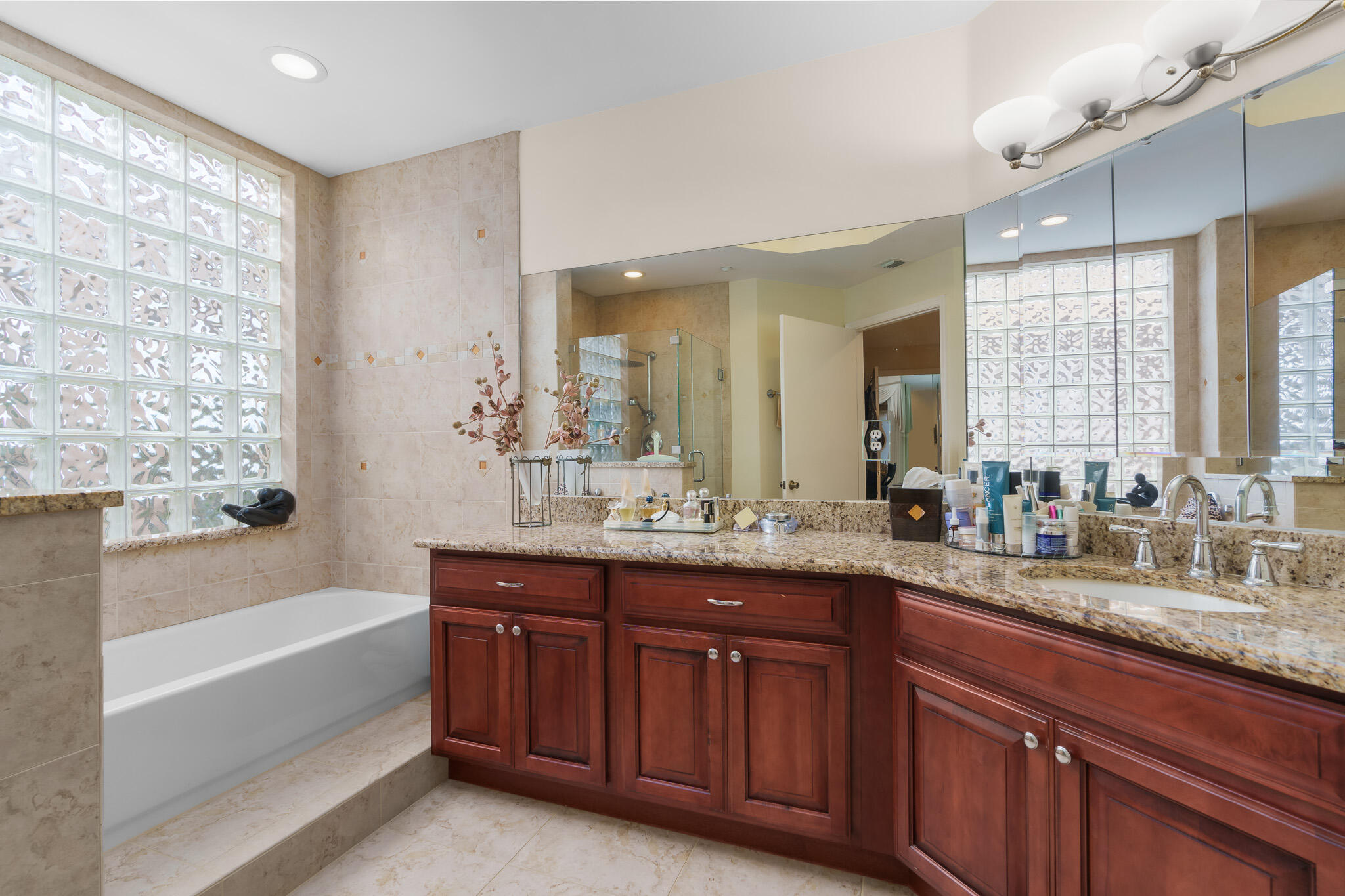 7546 La Paz Boulevard, Unit 405 Boca Raton, FL 33433 - Photo 19 of 43 a bathroom with a granite countertop sink mirror bathtub and double