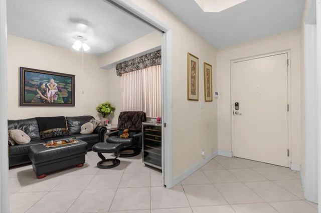 a living room with furniture and a dining table