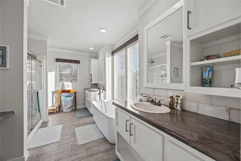 a large white kitchen with stainless steel appliances