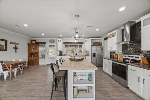 a kitchen with granite countertop a sink stove and cabinets