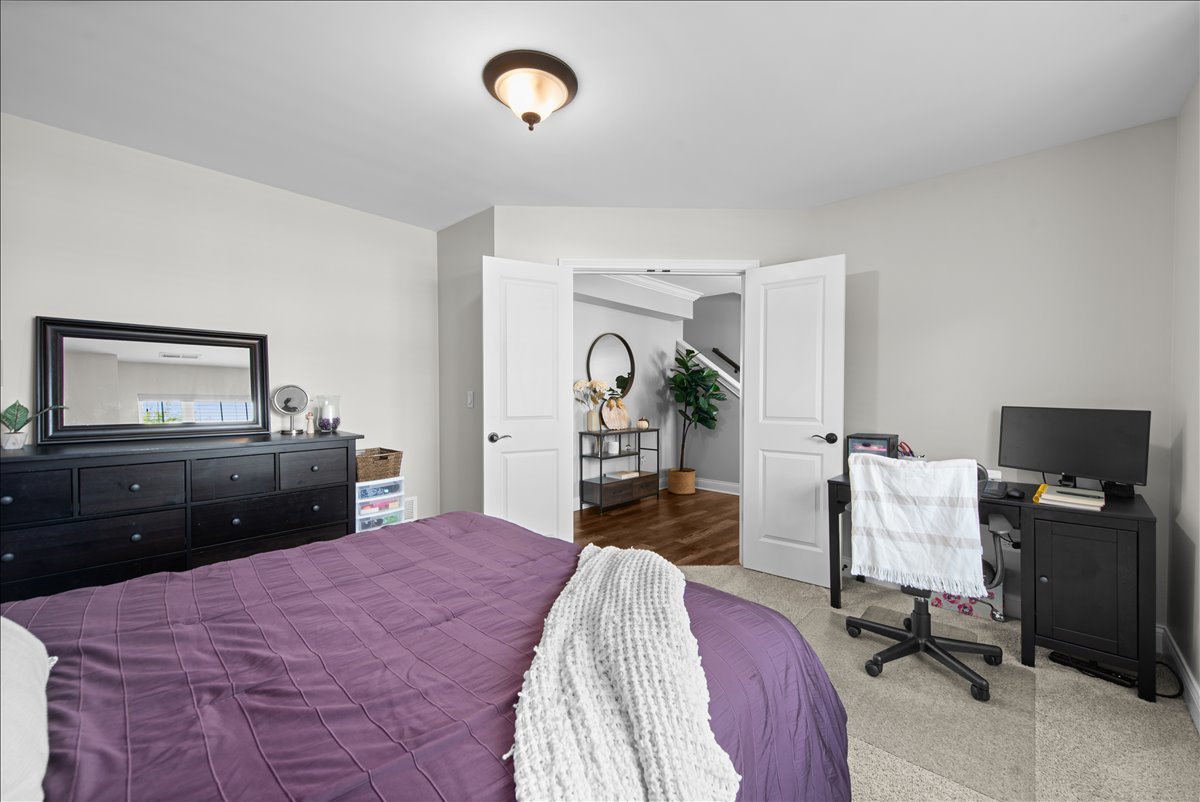 745 Harper Avenue Cary, IL 60013 - Photo 21 of 32 a bedroom with a bed and a chandelier