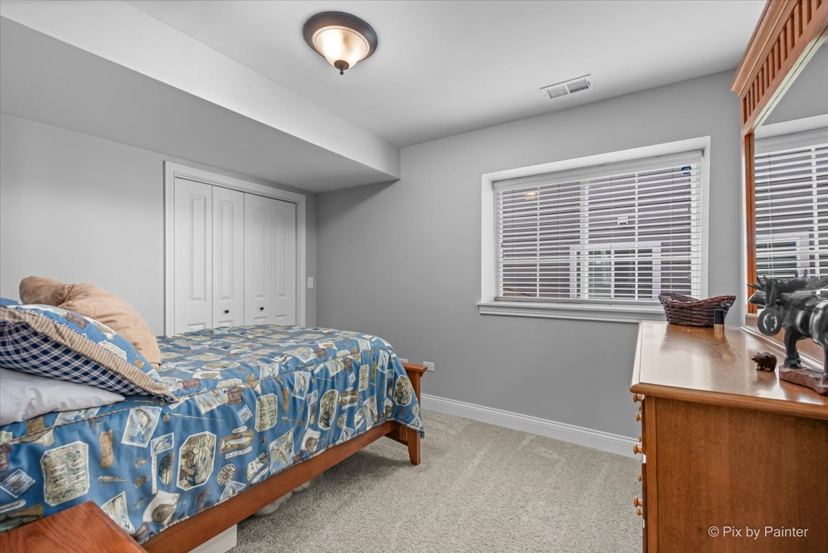 745 Harper Avenue Cary, IL 60013 - Photo 22 of 32 a bedroom with a bed and with windows