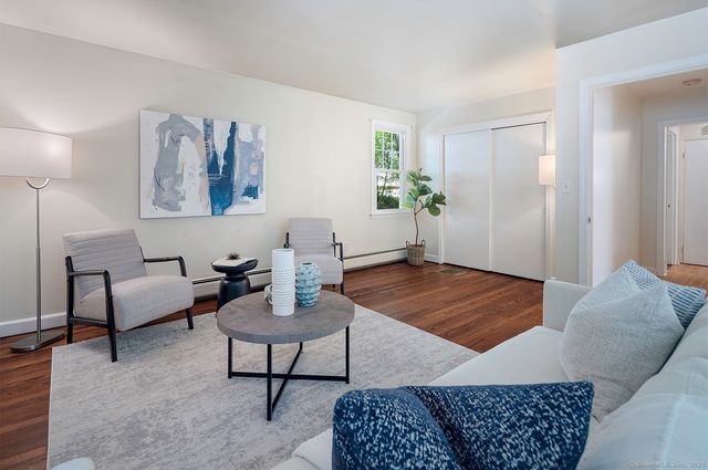 a living room with furniture and a rug