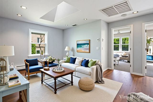 a living room with furniture and a potted plant