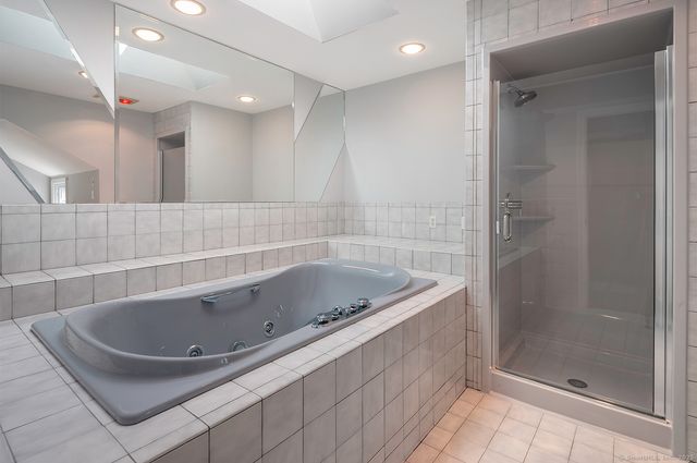 a bathroom with a tub a sink and a shower
