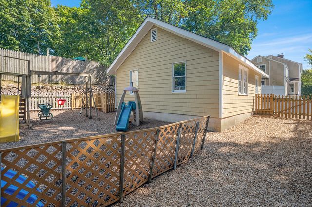 a view of a house with wooden fence