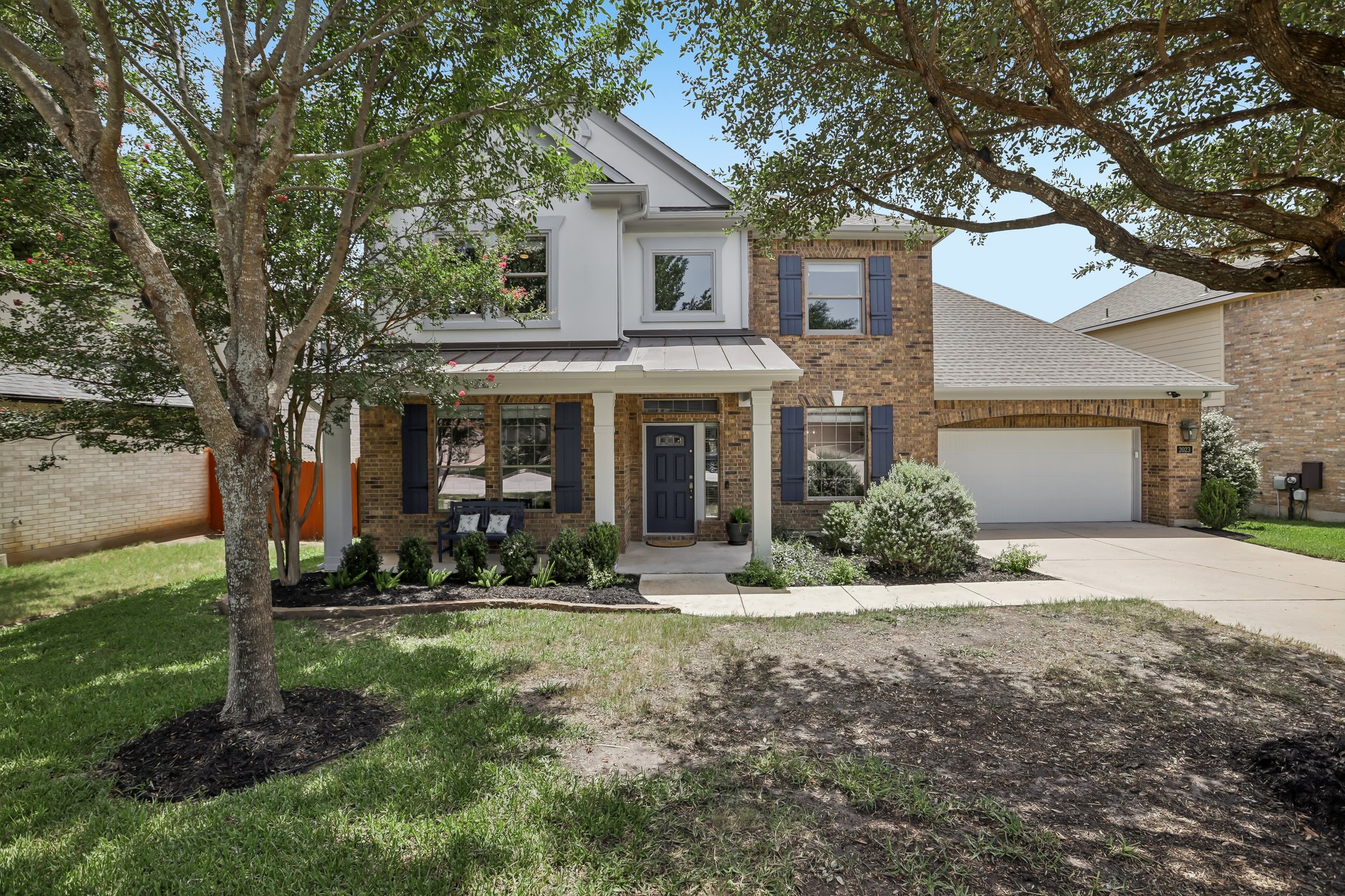 2023 Nelson Ranch Loop Cedar Park, TX 78613 - Photo 4 of 40 A well-maintained brick and siding facade with a welcoming covered entry and an attached garage.