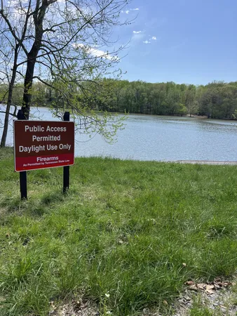 a view of a park bench next to a lake