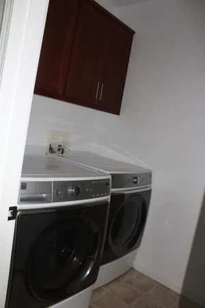 a utility room with washing machine