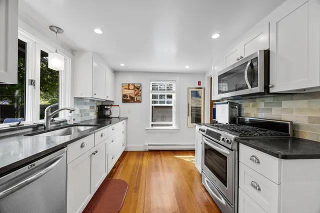 a living room with fireplace furniture and a table