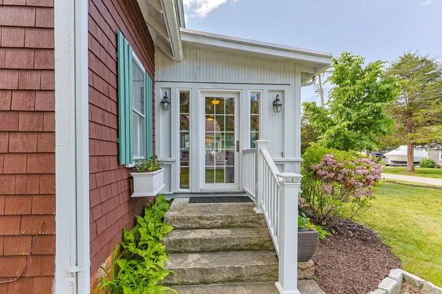 a living room with furniture a flat screen tv and a floor to ceiling window