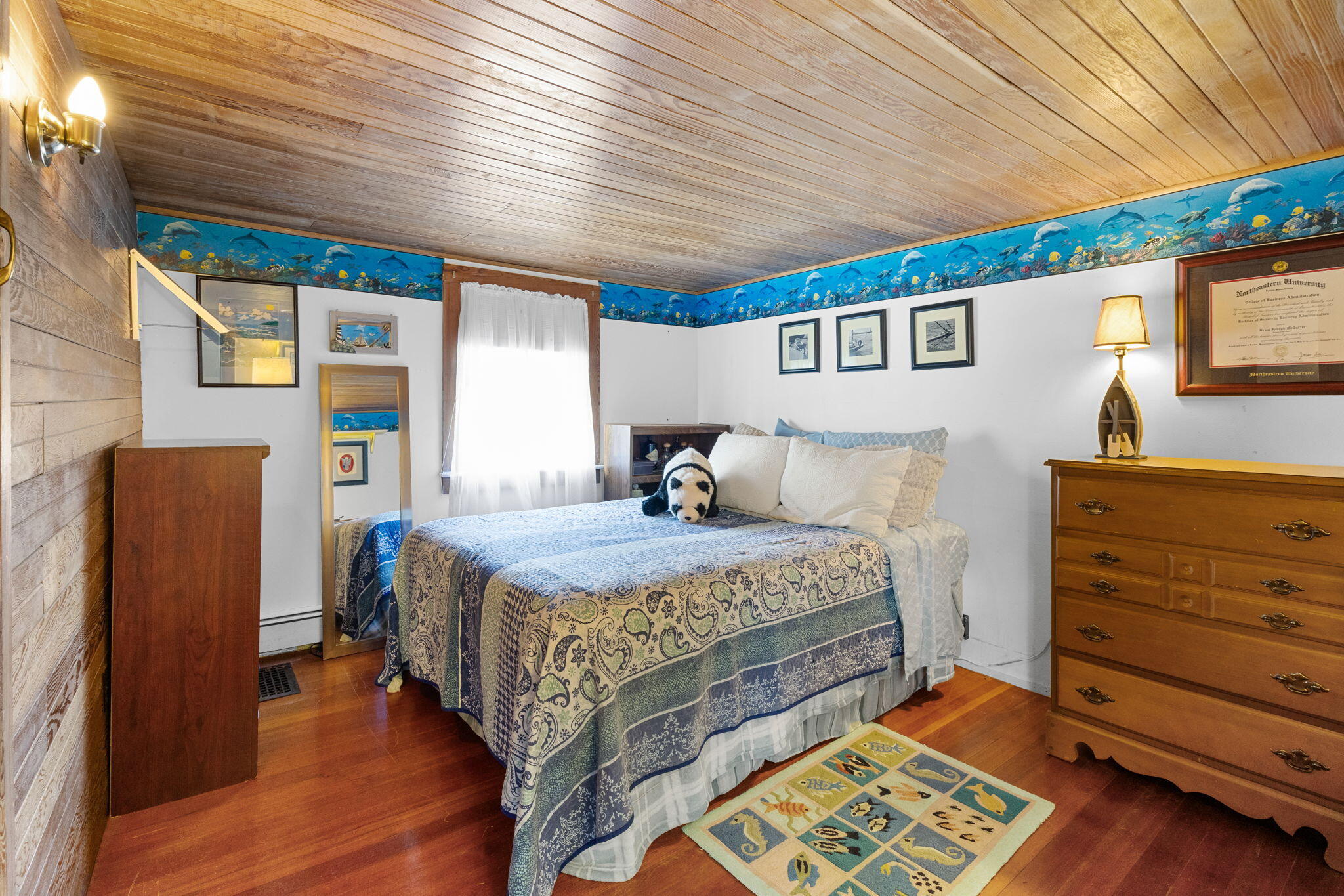 34 Kenwood Road Pocasset, MA 02559 - Photo 44 of 95 a bedroom with a bed and a dresser