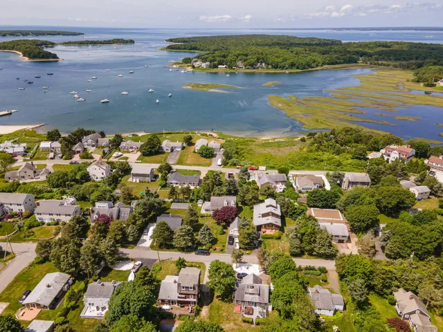 a living room with furniture a flat screen tv and windows
