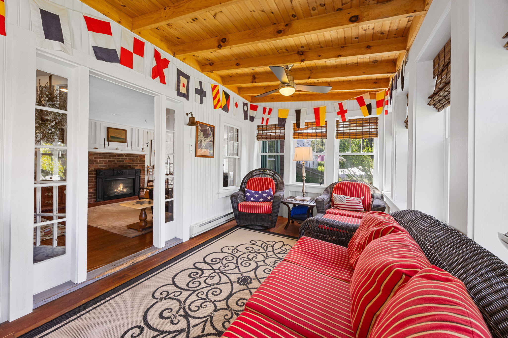 34 Kenwood Road Pocasset, MA 02559 - Photo 56 of 95 a living room with furniture a flat screen tv and a floor to ceiling window