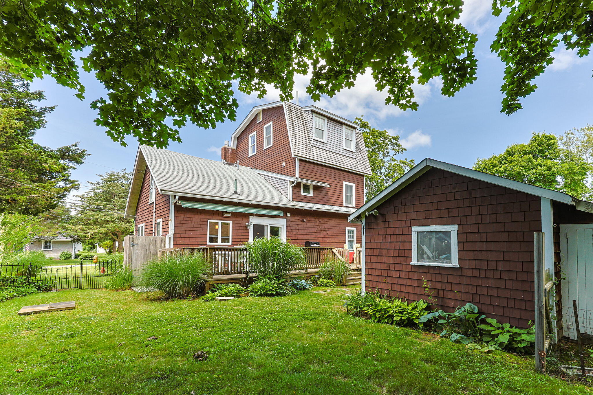 34 Kenwood Road Pocasset, MA 02559 - Photo 62 of 95 a front view of a house with a yard and trees