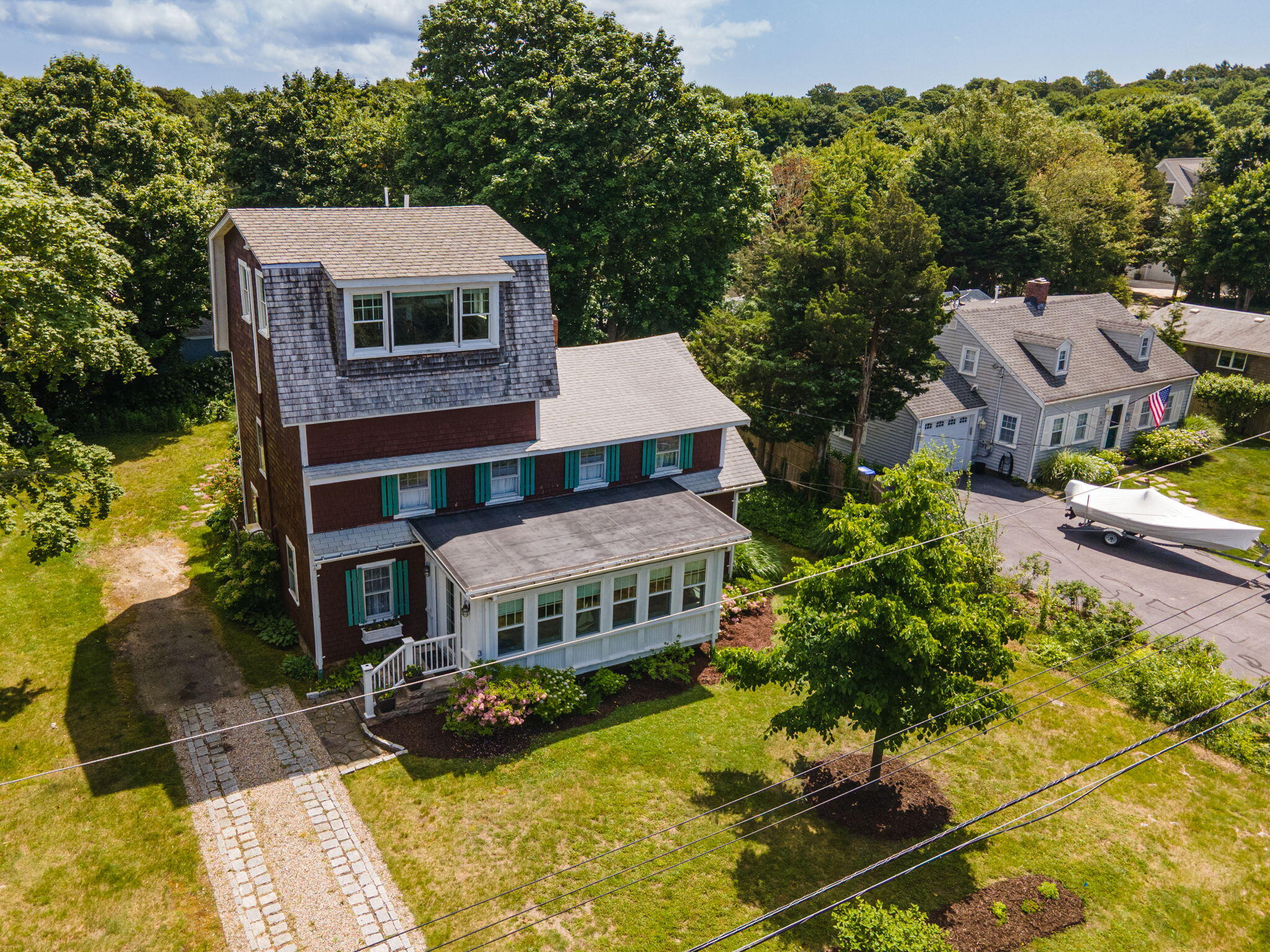 34 Kenwood Road Pocasset, MA 02559 - Photo 65 of 95 an aerial view of a house with swimming pool and trees in the background