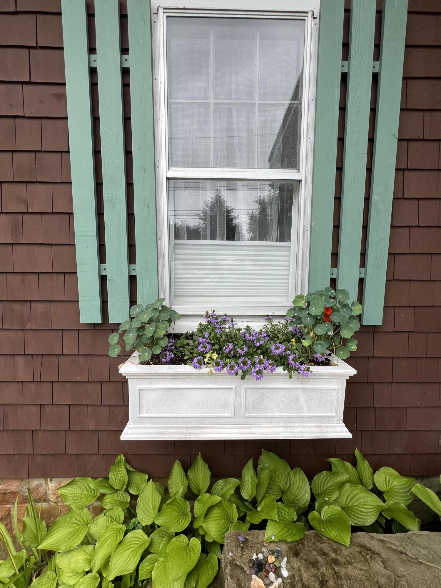 34 Kenwood Road Pocasset, MA 02559 - Photo 80 of 95 a front view of a house with a garden