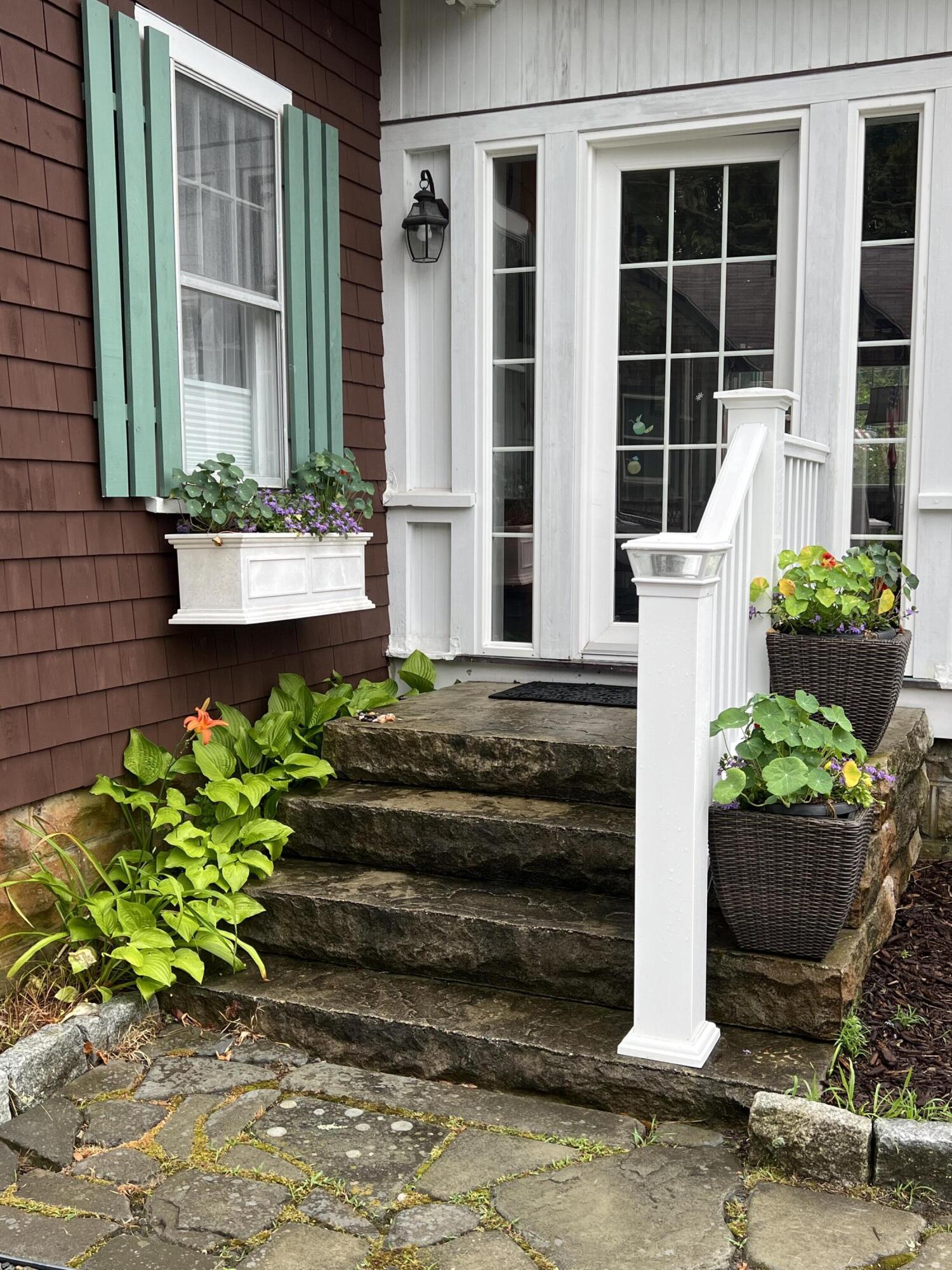 34 Kenwood Road Pocasset, MA 02559 - Photo 81 of 95 a front view of a house with potted plants