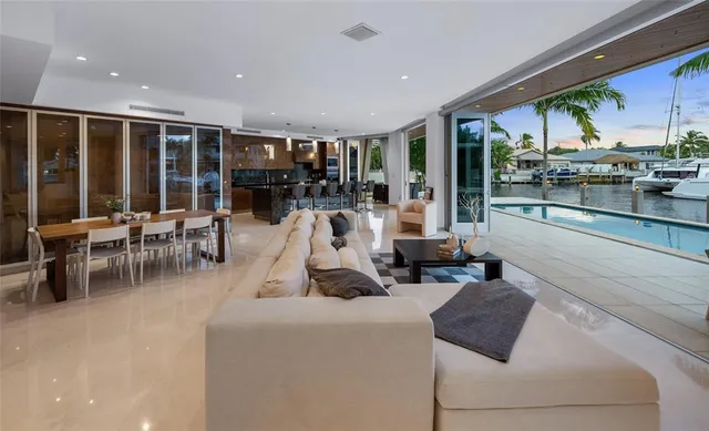 a living room with furniture a flat screen tv and a large window