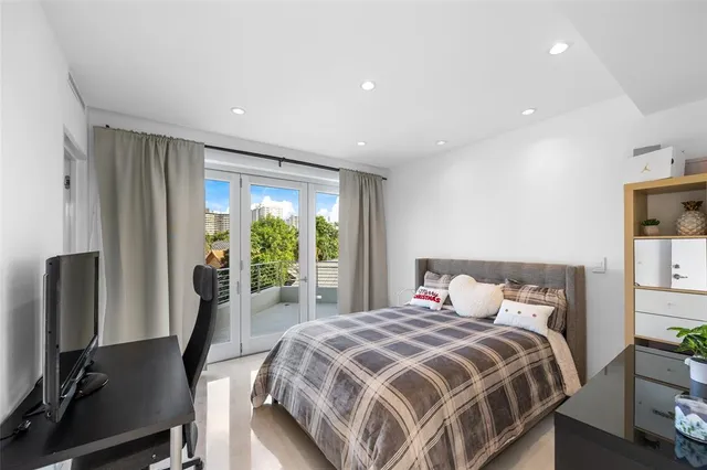 a spacious bedroom with a bed and a chair