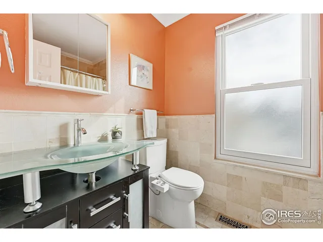 a bathroom with a sink a toilet a mirror and shower