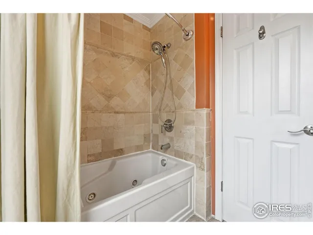 a bathroom with a tub a sink and a shower