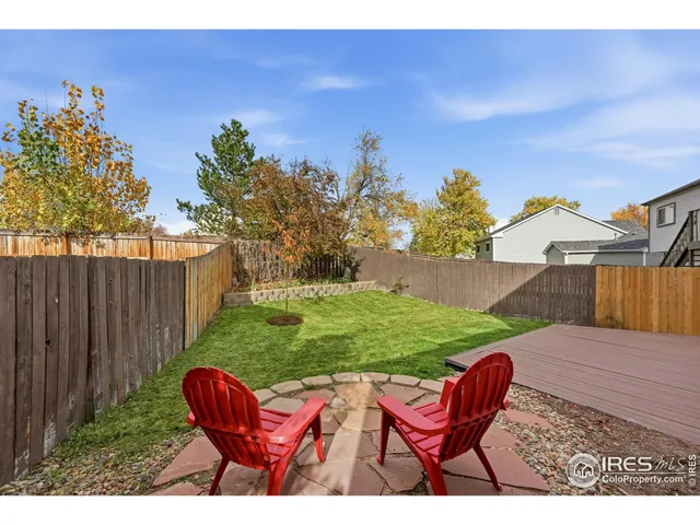 a view of a backyard with sitting area
