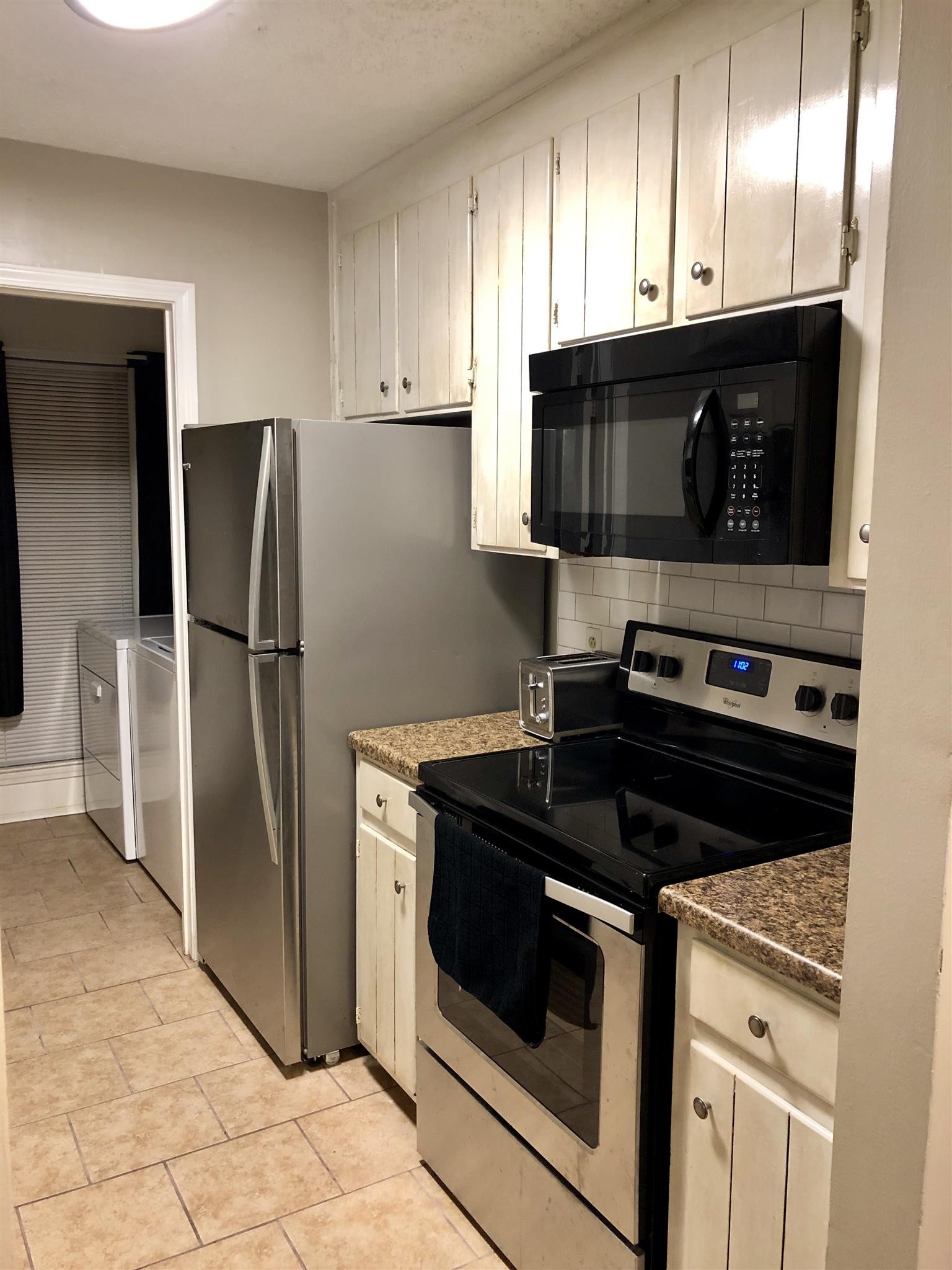 4316 Baton Rouge Drive Hermitage, TN 37076 - Photo 2 of 10 a kitchen with stainless steel appliances granite countertop a stove a refrigerator and a microwave