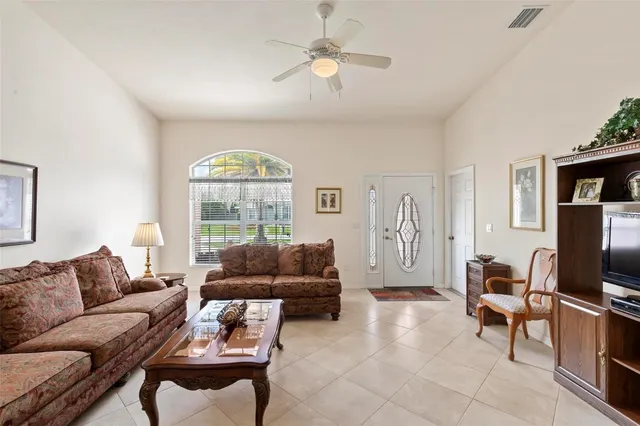 a view of a dining room with furniture and a chandelier