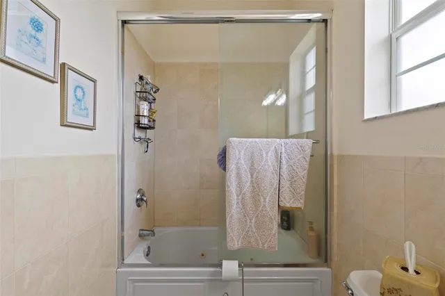 a bathroom with a sink vanity mirror and toilet