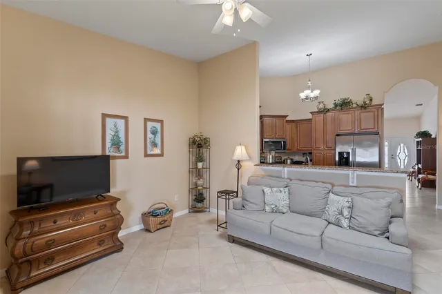a living room with furniture and a chandelier