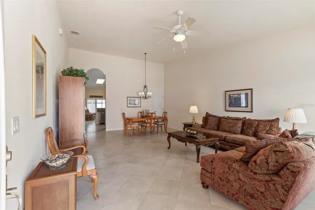a living room with furniture a table and a chandelier