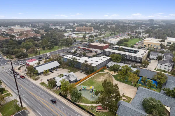 an aerial view of residential houses with outdoor space