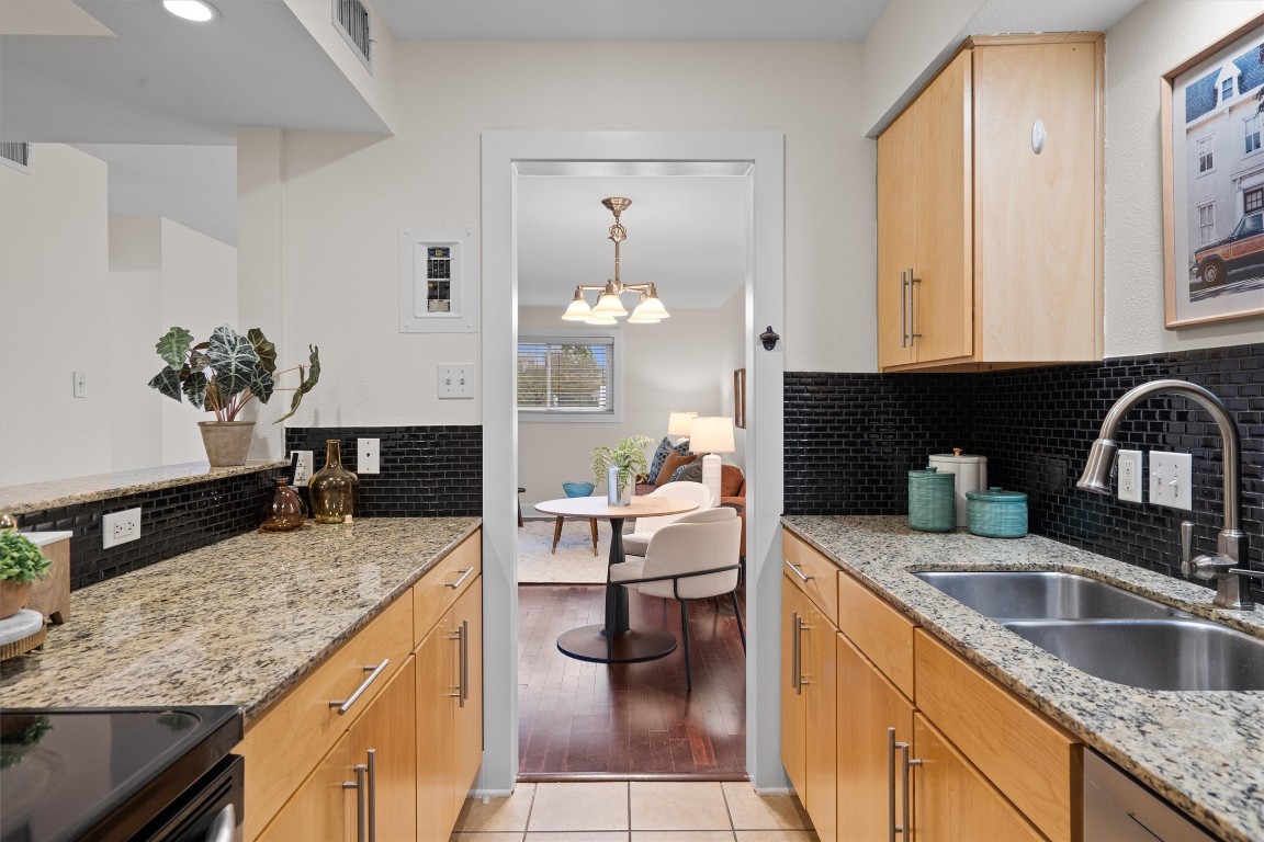 3815 Guadalupe Street, Unit 204 Austin, TX 78751 - Photo 2 of 19 a kitchen with granite countertop a sink dishwasher stove and cabinets