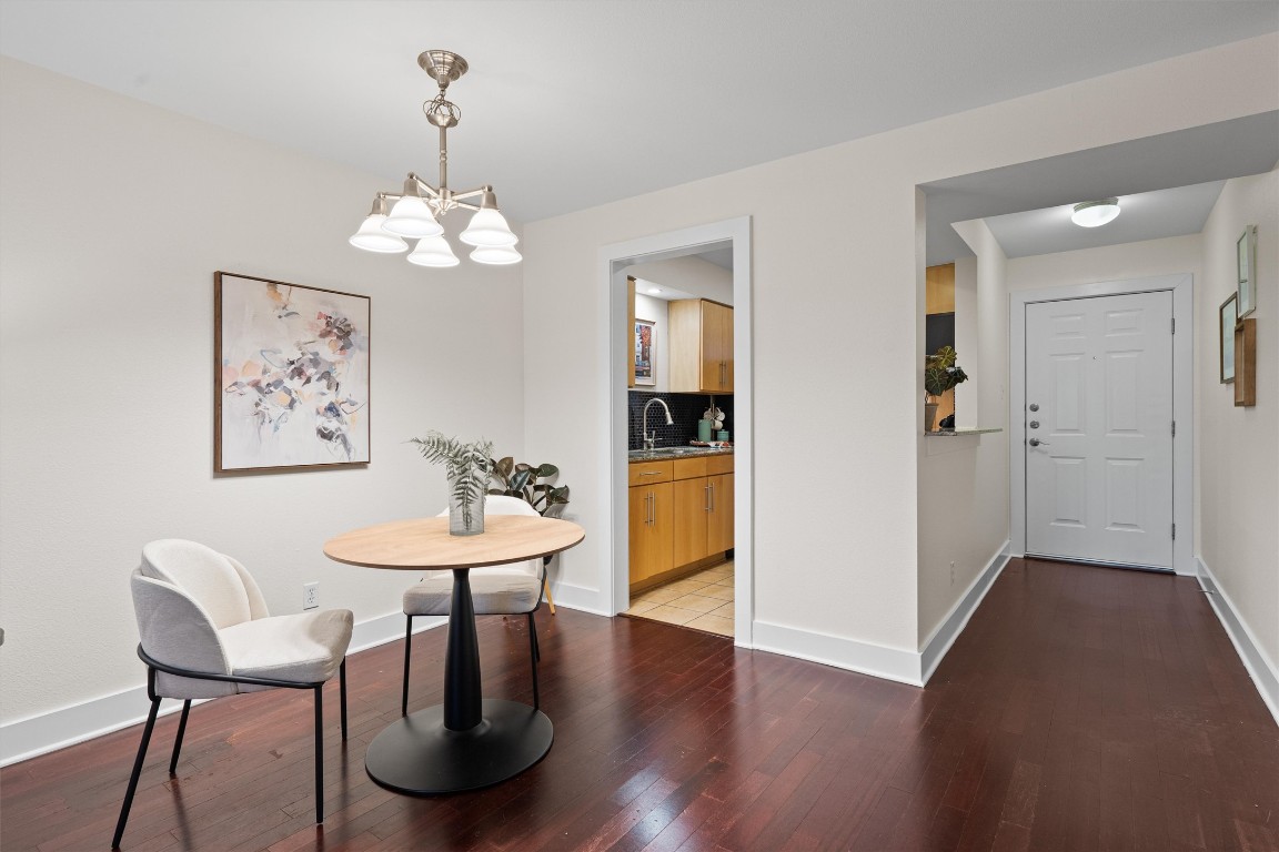 3815 Guadalupe Street, Unit 204 Austin, TX 78751 - Photo 6 of 19 a view of a dining room with furniture wooden floor and a chandelier