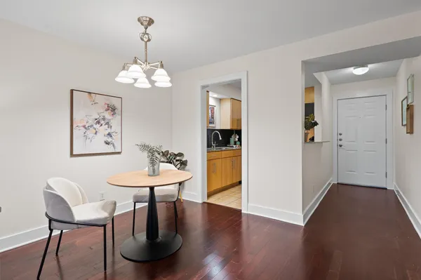 a view of a dining room with furniture wooden floor and a chandelier