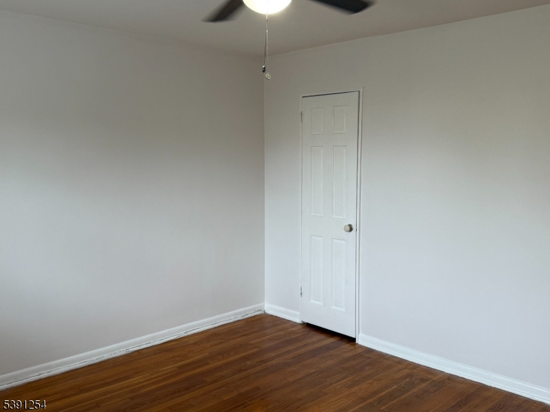 799 Mountain Avenue, Unit D Springfield, NJ 07081 - Photo 15 of 16 a view of an empty room with wooden floor and fan