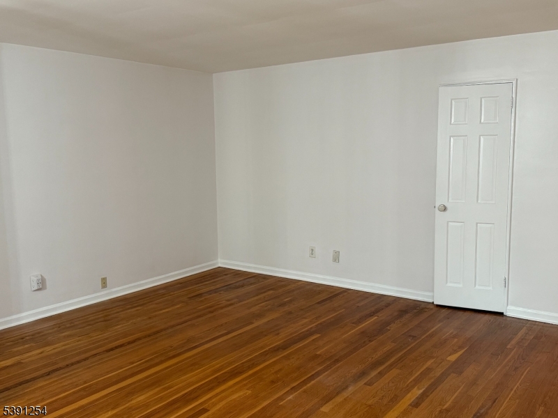 799 Mountain Avenue, Unit D Springfield, NJ 07081 - Photo 3 of 16 a view of an empty room with wooden floor