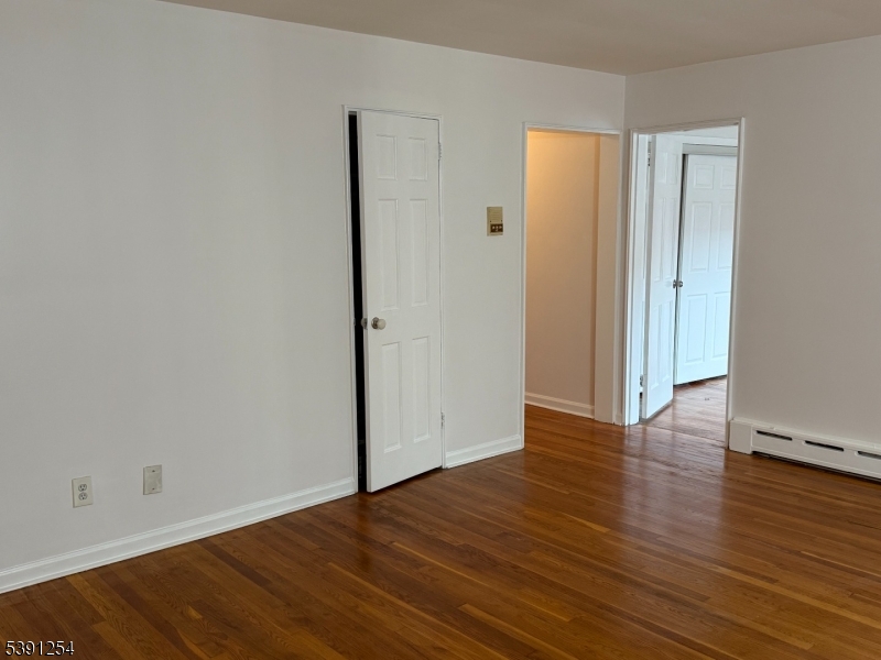 799 Mountain Avenue, Unit D Springfield, NJ 07081 - Photo 4 of 16 a view of an empty room with wooden floor and closet
