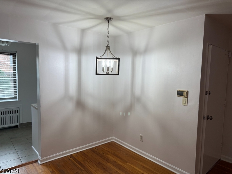 799 Mountain Avenue, Unit D Springfield, NJ 07081 - Photo 5 of 16 a view of a room with a wooden floor and a window