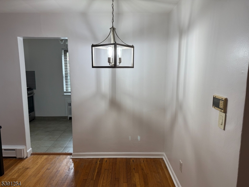 799 Mountain Avenue, Unit D Springfield, NJ 07081 - Photo 6 of 16 an empty room with wooden floor and windows