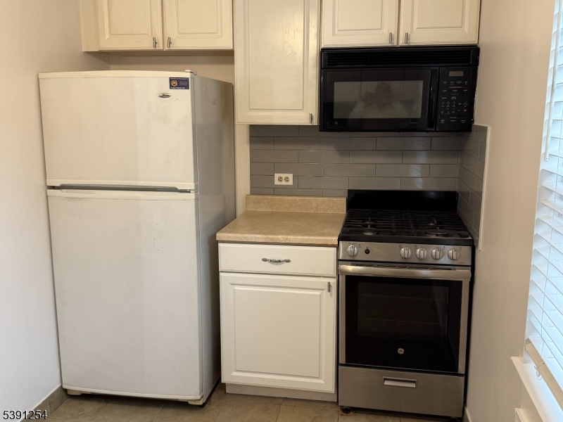 799 Mountain Avenue, Unit D Springfield, NJ 07081 - Photo 7 of 16 a white refrigerator freezer and a stove sitting inside of a kitchen