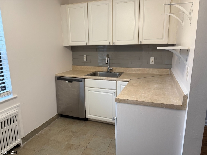 799 Mountain Avenue, Unit D Springfield, NJ 07081 - Photo 8 of 16 a kitchen with a sink stove and cabinets
